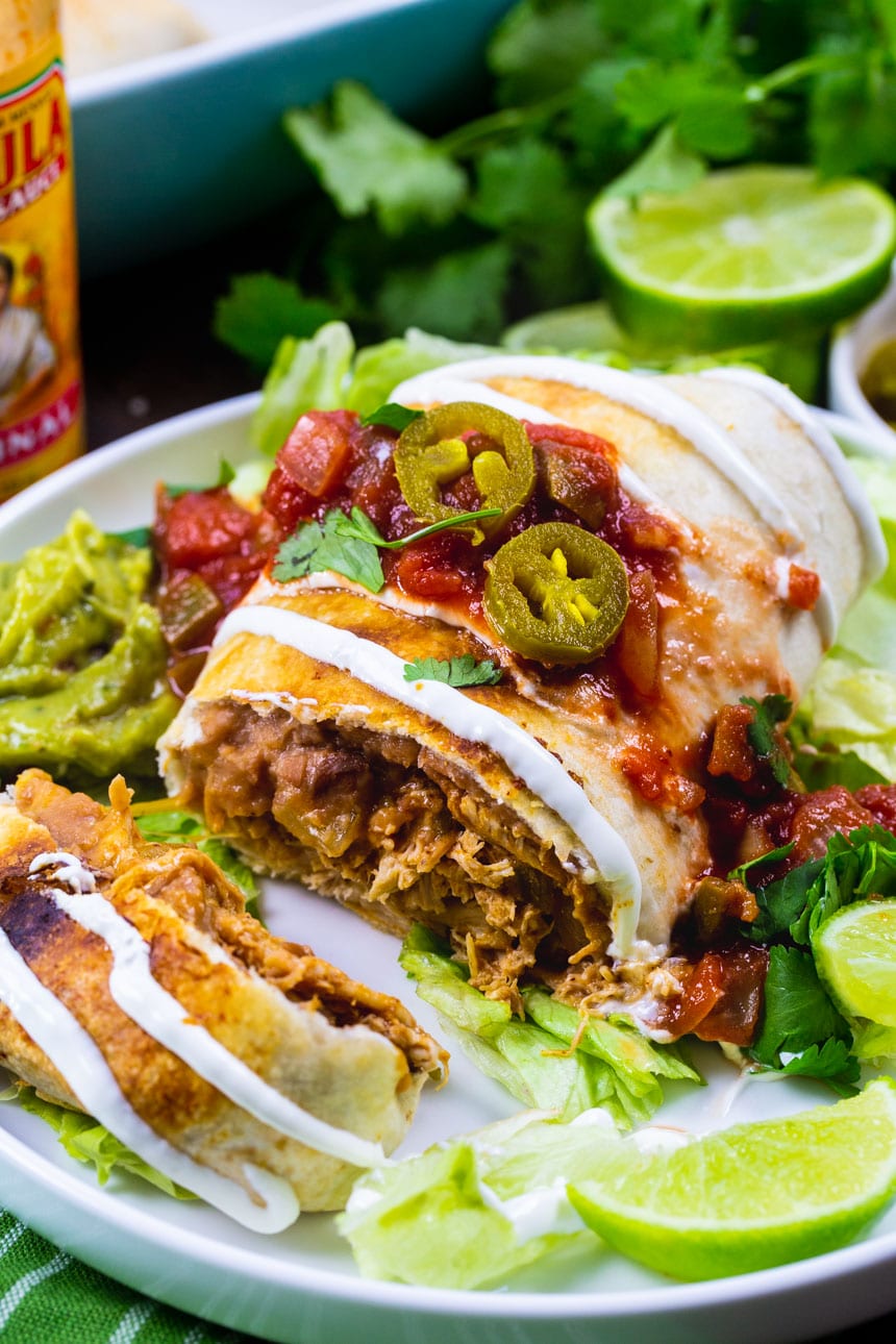 Chicken Chimichanga on a plate with toppings.