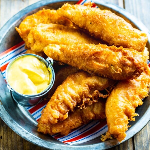 Chicken Crispers in a metal serving dish with honey mustard.