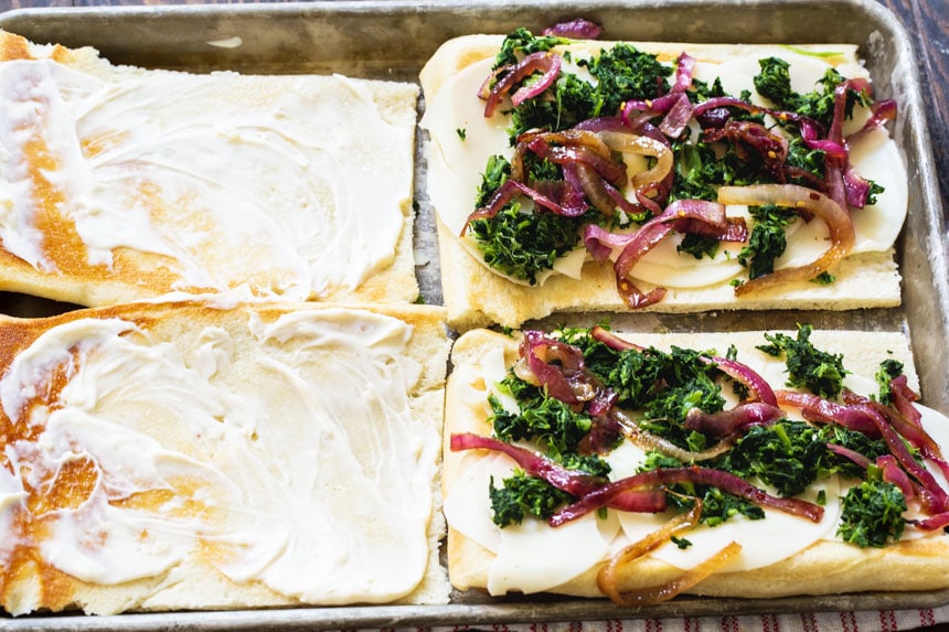 Flat bread topped with spinach/onion mixture.