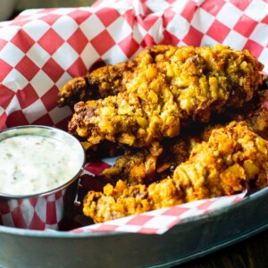 Chicken Fried Steak Fingers in a basket with mustard sauce.