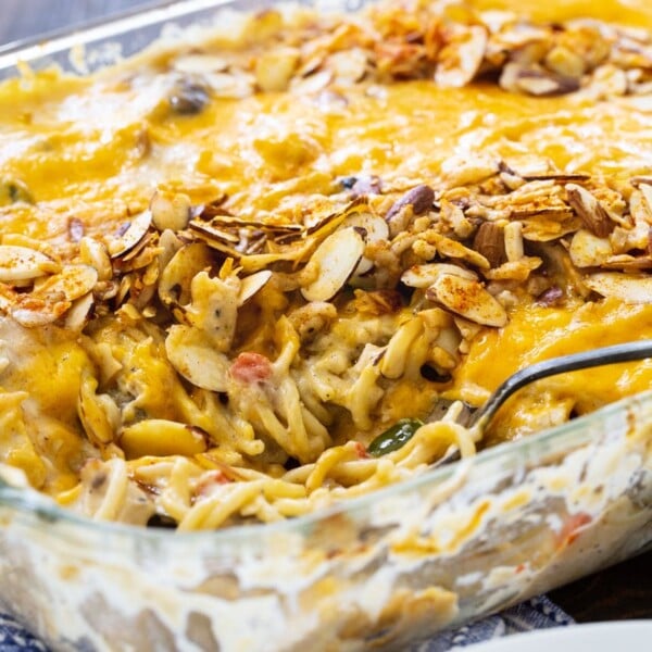 Tetrazzini in a baking dish with a serving spoon.