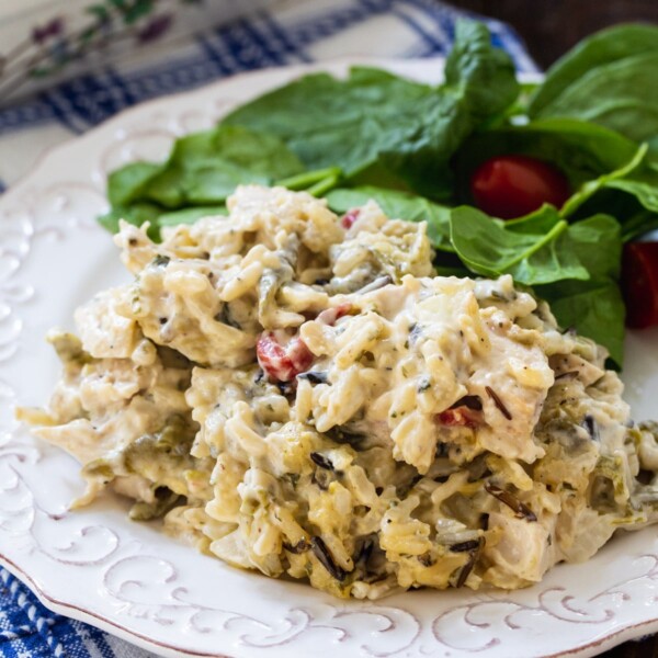 Serving of Chicken Wild Rice Casserole on a plate with salad.