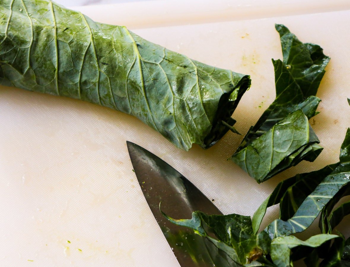 Collard green leaves rolled up to be cut.