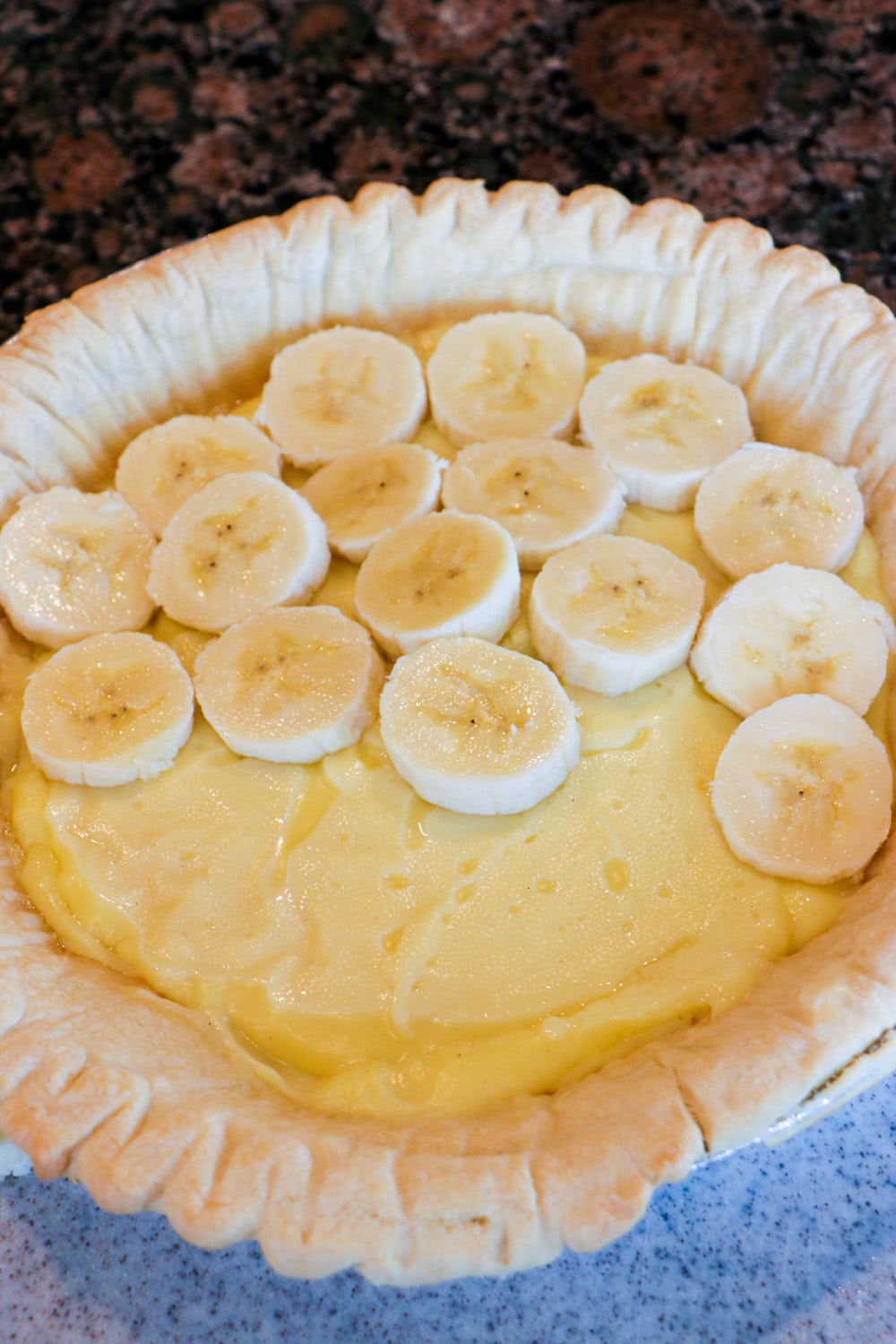 Banana slices placed on top of pudding layer.