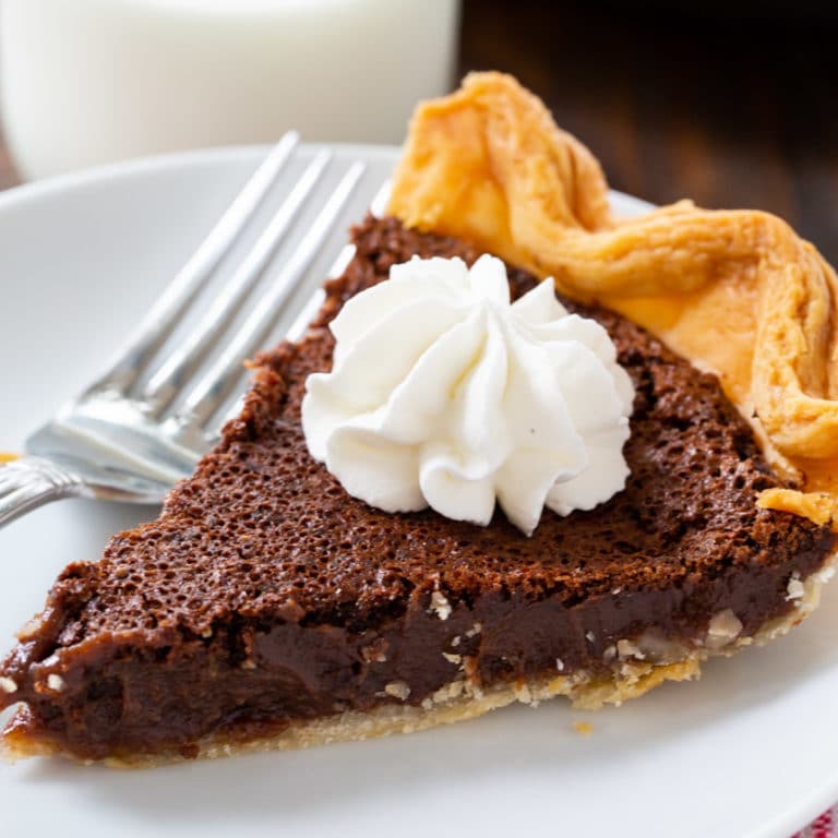 Chocolate Chess Pie slice topped with whipped cream.