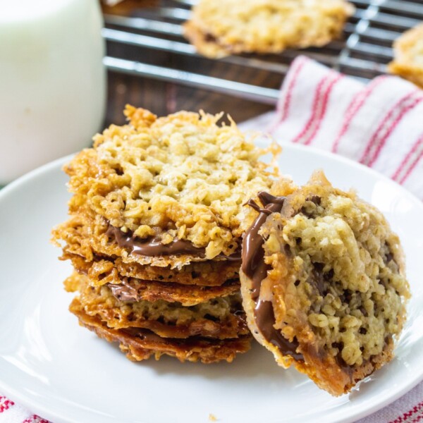 Chocolate Florentine Cookies stacked on a plate.