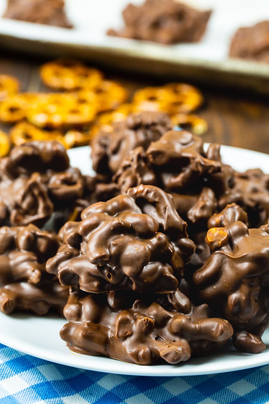 Chocolate Peanut Clusters with Pretzels on a plate.