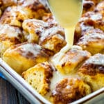 Spoon drizzling icing on Cinnamon Roll Bites