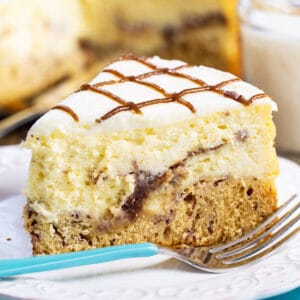 Slice of Cinnamon Roll Cheesecake on a plate.