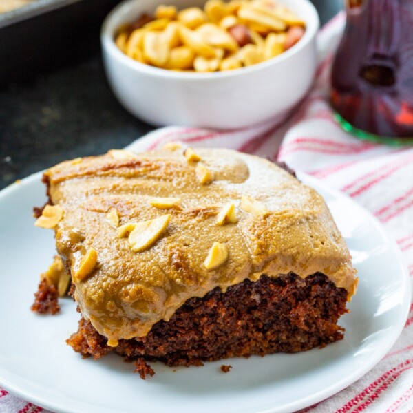 Slice of Coca-Cola Cake with Broiled Peanut Frosting on a plate.