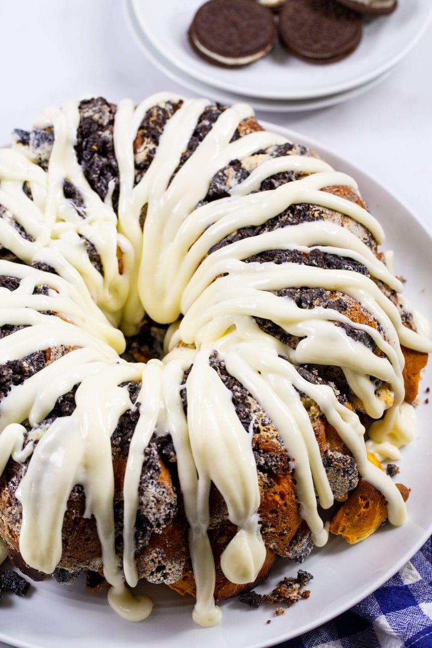 Monkey Bread covered in glaze on a serving platter.