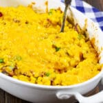 Cheesy Corn Casserole with Bacon in oval baking dish.