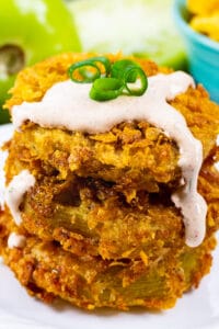 Stack of Cornflake Crusted Fried Green Tomatoes topped with Chipotle Mayo.
