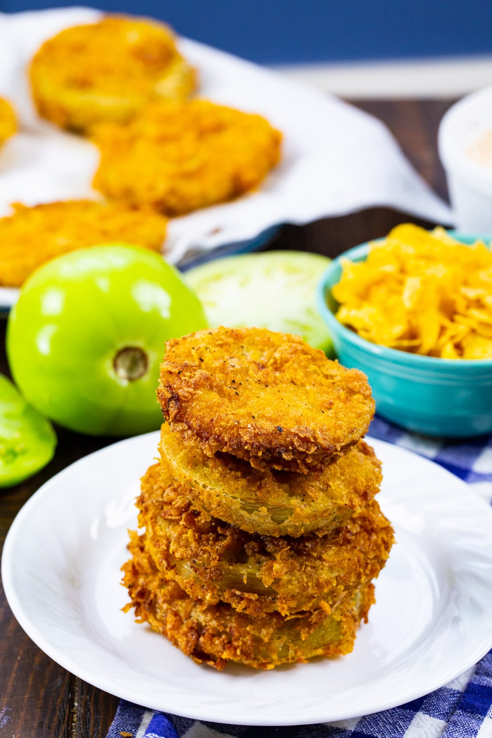 Stack of fried green tomatoes on a plate.