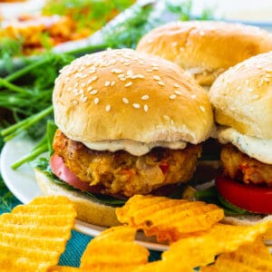 Crawfish Burgers on a plate with potato chips.