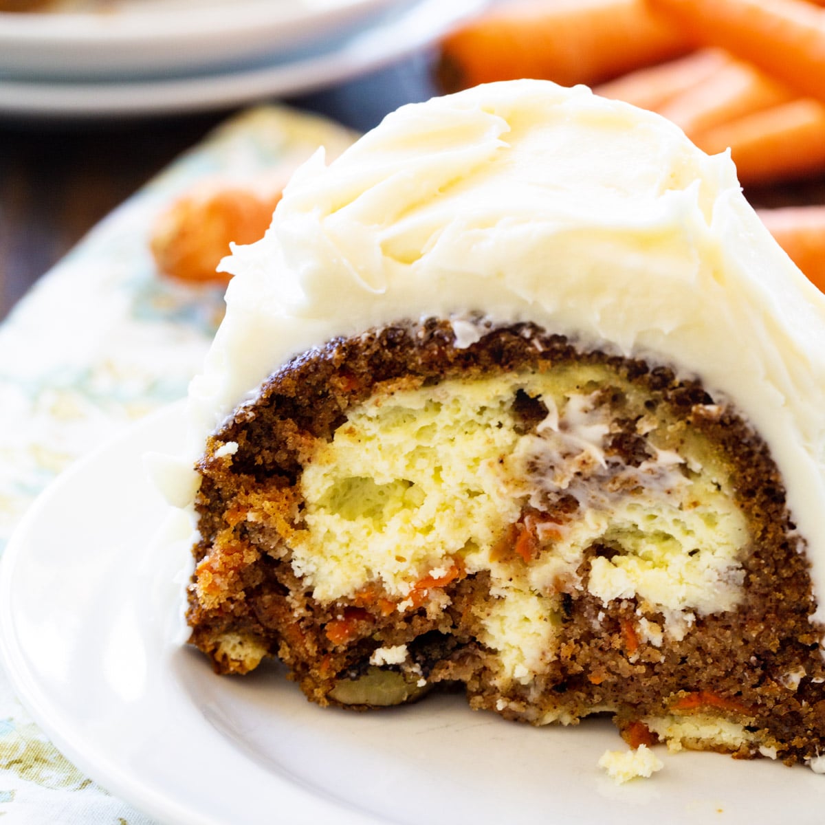 Slice of Cream Cheese Filled Carrot Cake on a plate.