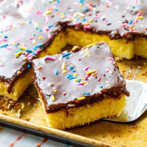 square slice of sheet cake with chocolate icing and sprinkles
