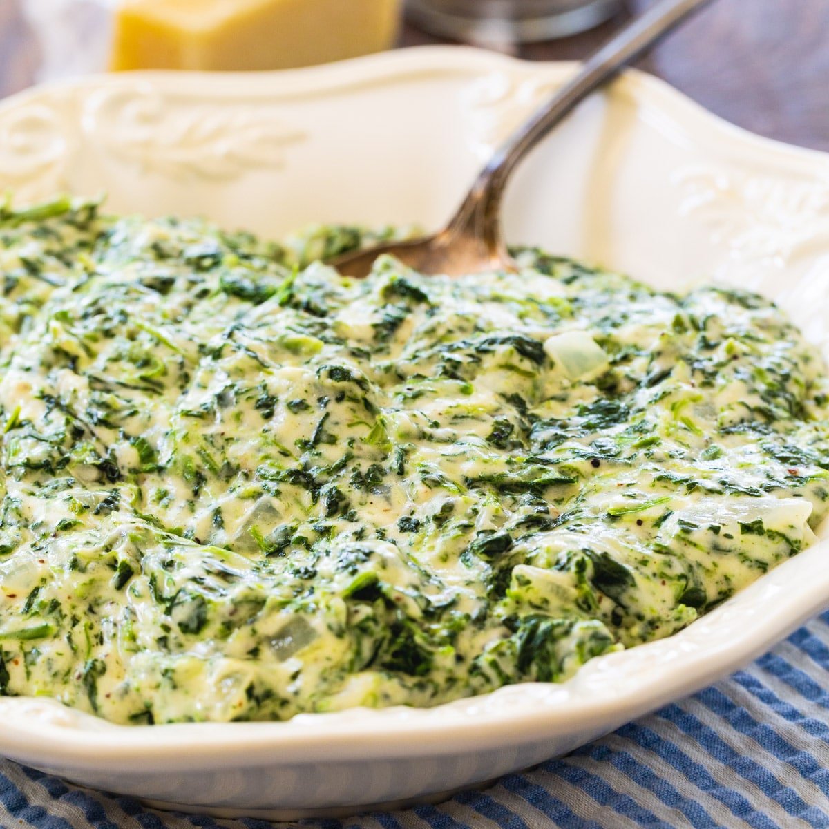 Creamed Spinach in a bowl with a spoon.
