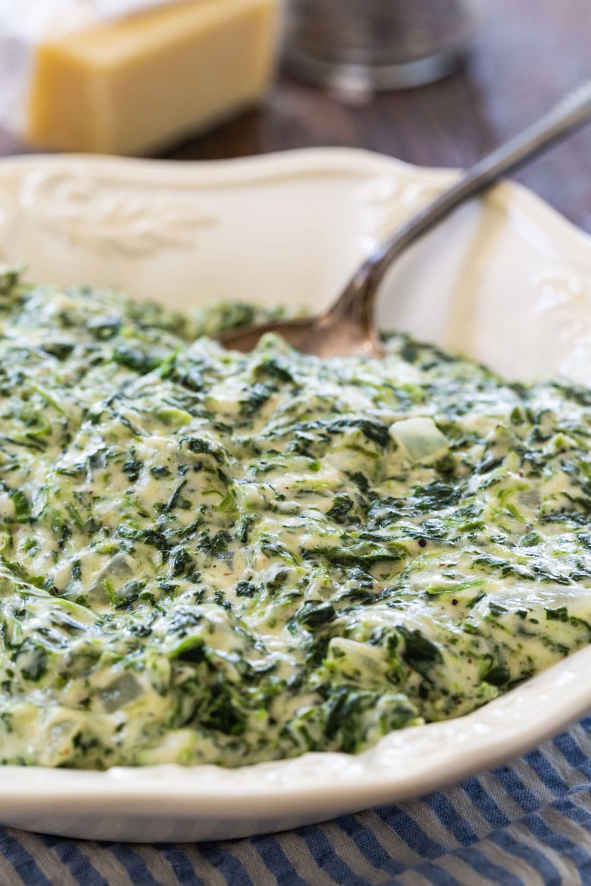 Creamed Spinach in a white serving bowl.