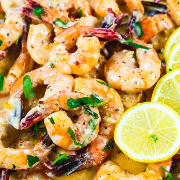 Creamy Lemon Garlic Butter Shrimp in a skillet with lemon slices.