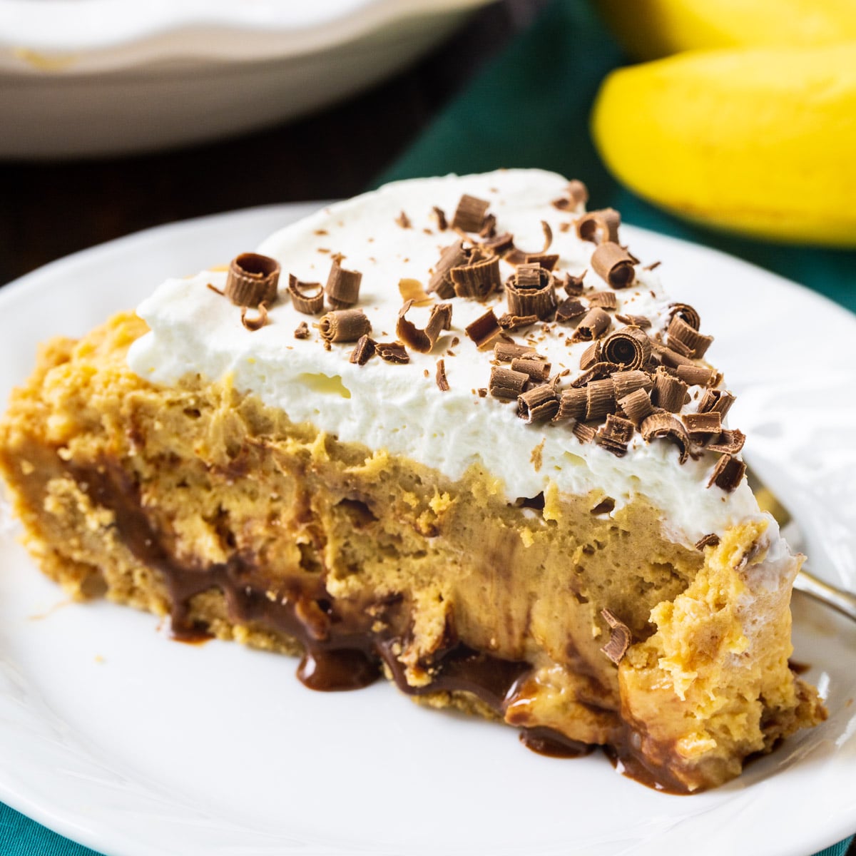 Slice of Creamy Peanut Butter Banana Pie on a plate.