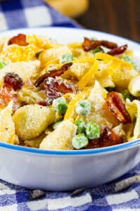 Small bowl full of Creamy Pasta Salad with Peas and Bacon.