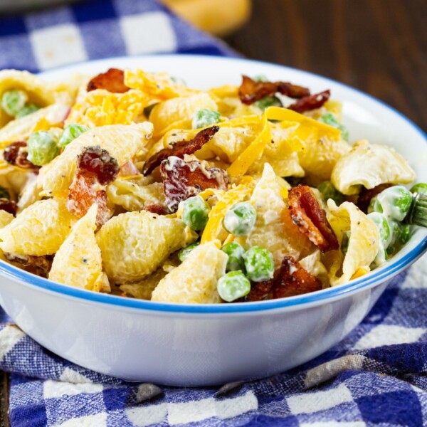 Small bowl full of Creamy Pasta Salad with Peas and Bacon.