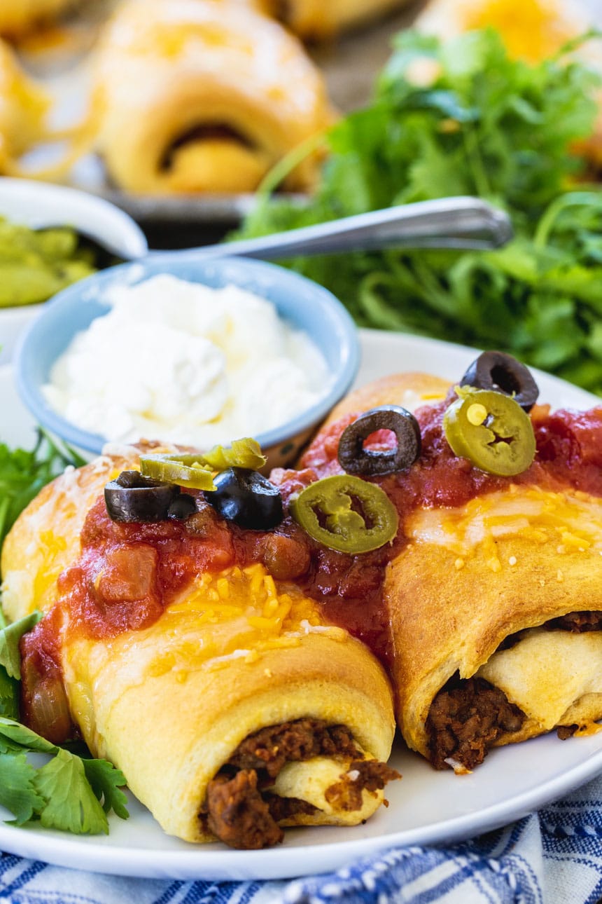 Beef Burrito Bundles topped with salsa and olives.