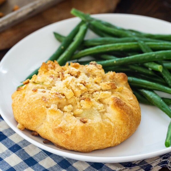 Crescent Chicken Bundle on a plate with green beans.