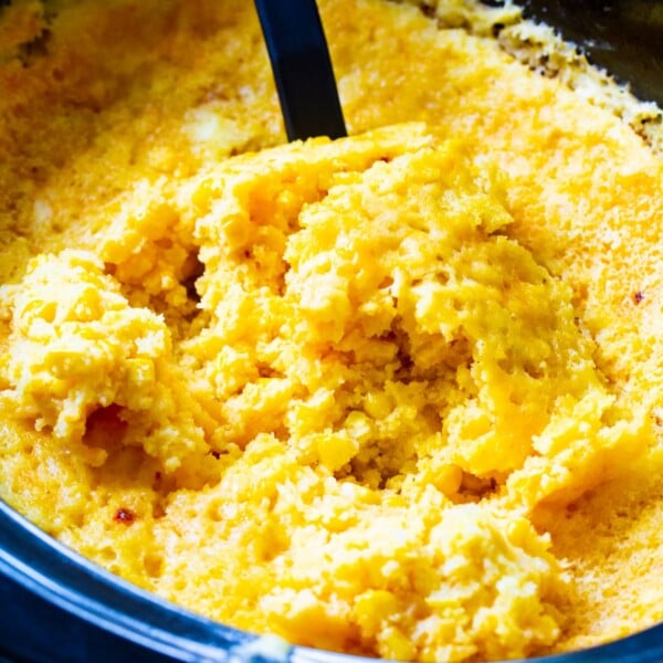 Spoon scooping Crock Pot Corn Casserole.