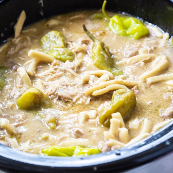 Crock Pot Mississippi Chicken and Noodles in black slow cooker.