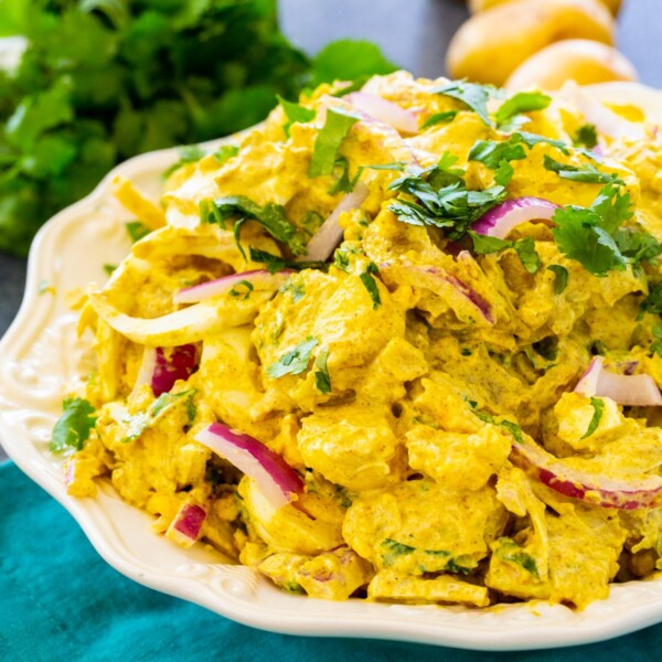 Curried Potato Salad topped with cilantro in a serving bowl.