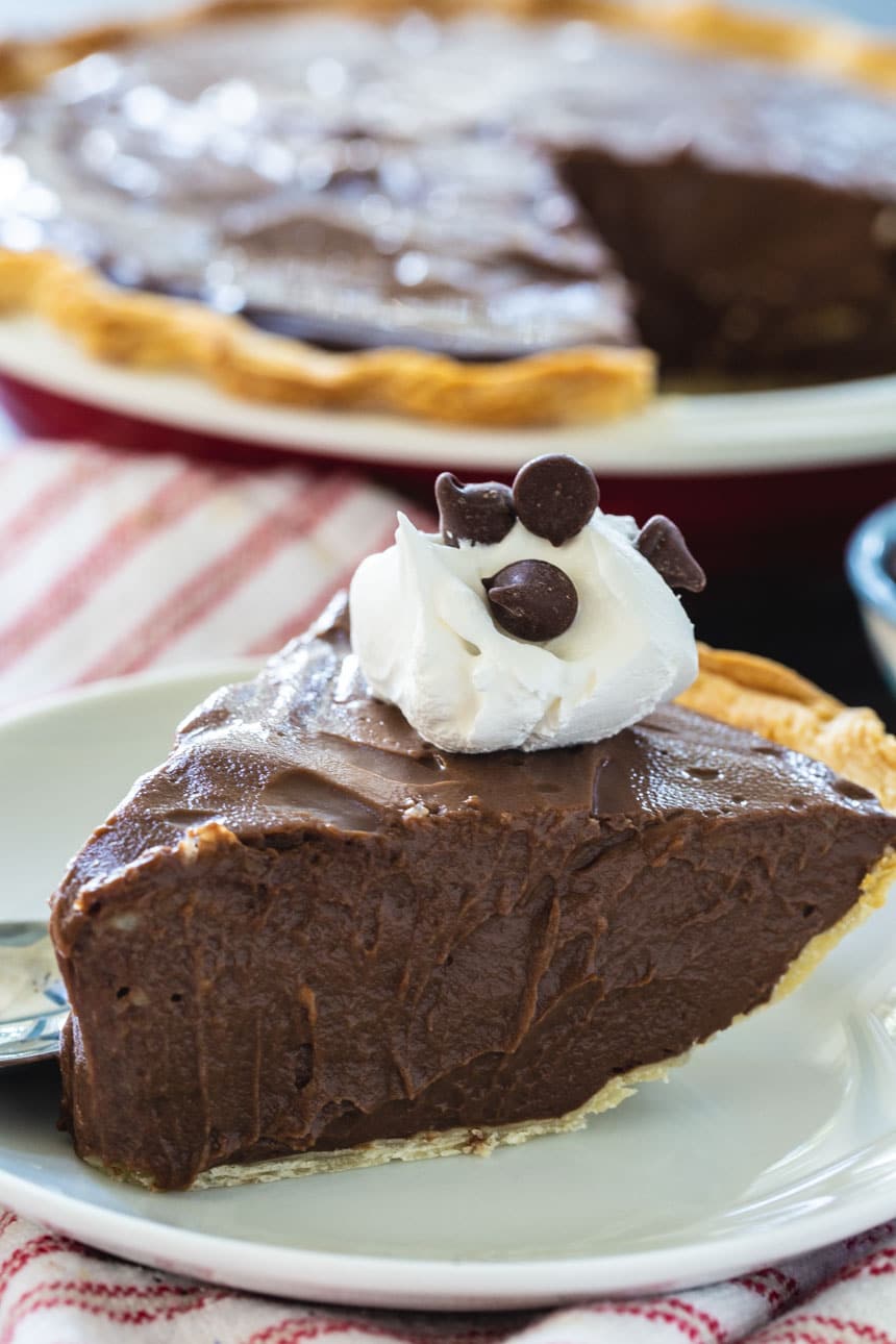 Slice of Chocolate Pie topped with whipped cream.