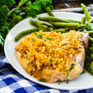 Deviled Pork Chops on a plate with green beans.