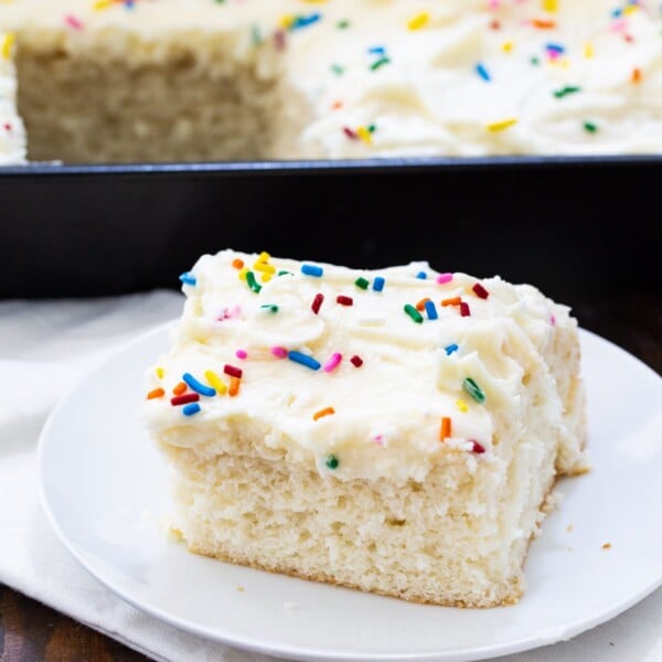 Slice of Doctored Cake Mix White Sheet Cake on a plate.