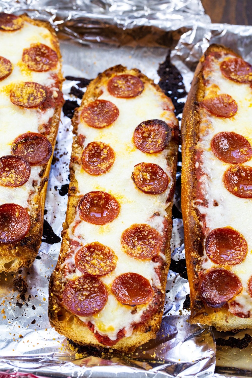 Three pices of French Bread Pizza topped with pepperoni.