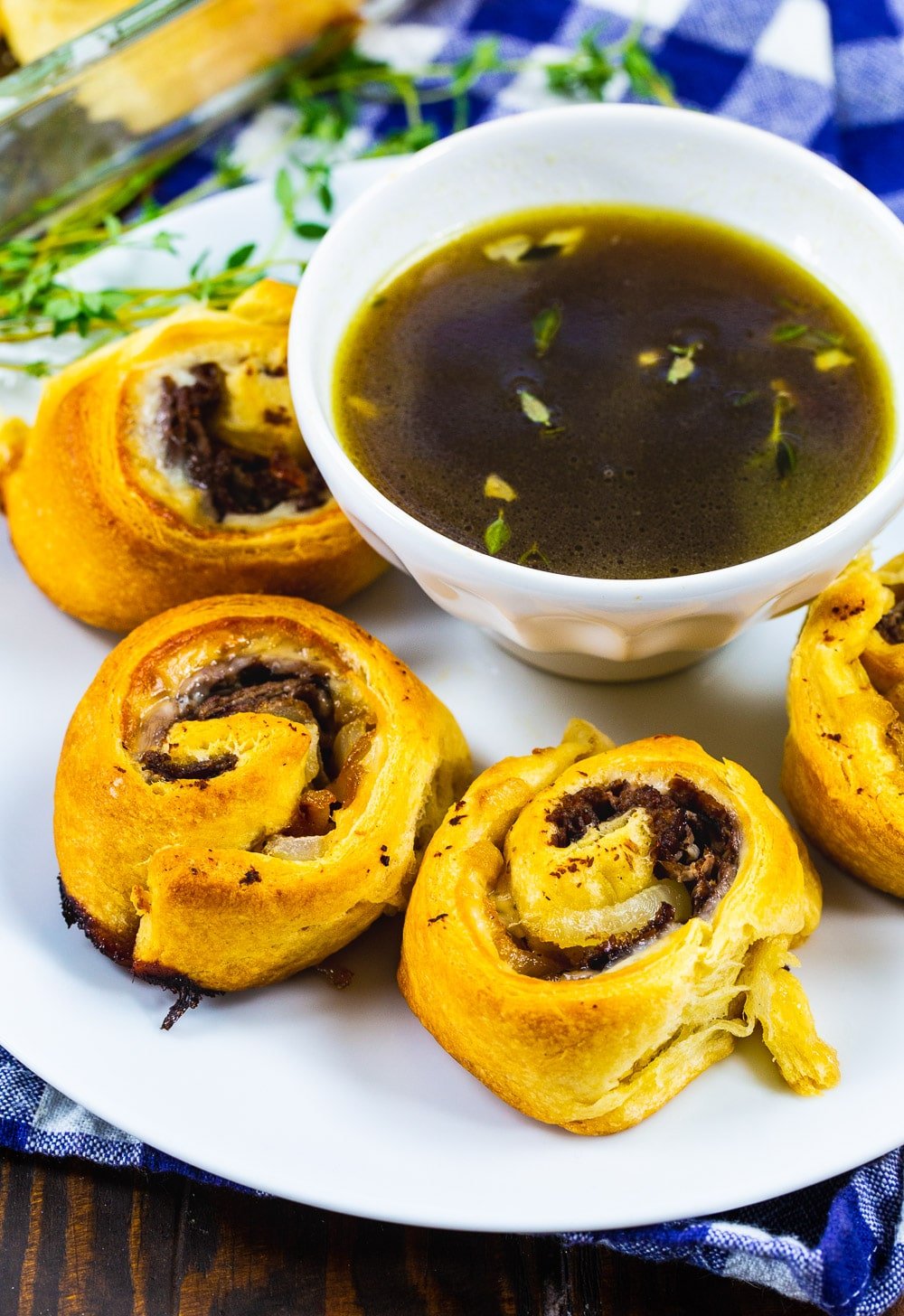 French Dip Pinwheels on a plate with Au Jus.