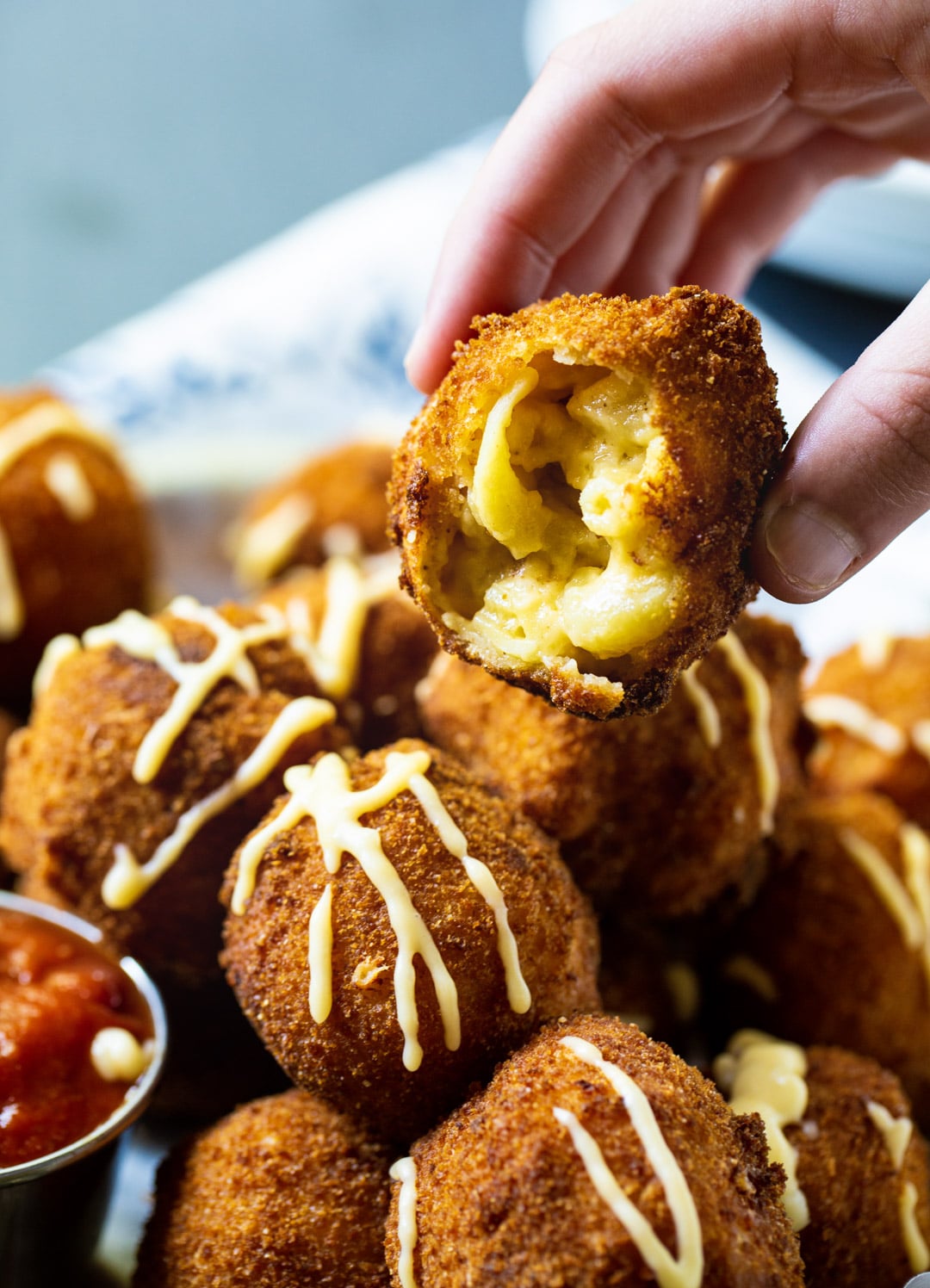 Hand holding mac and cheese ball.