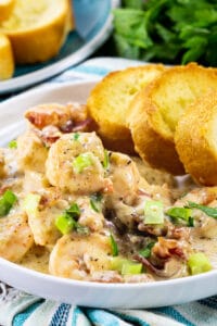 Garlic Shrimp with Creamy Parmesan Sauce with toasted baguette slices on a plate.
