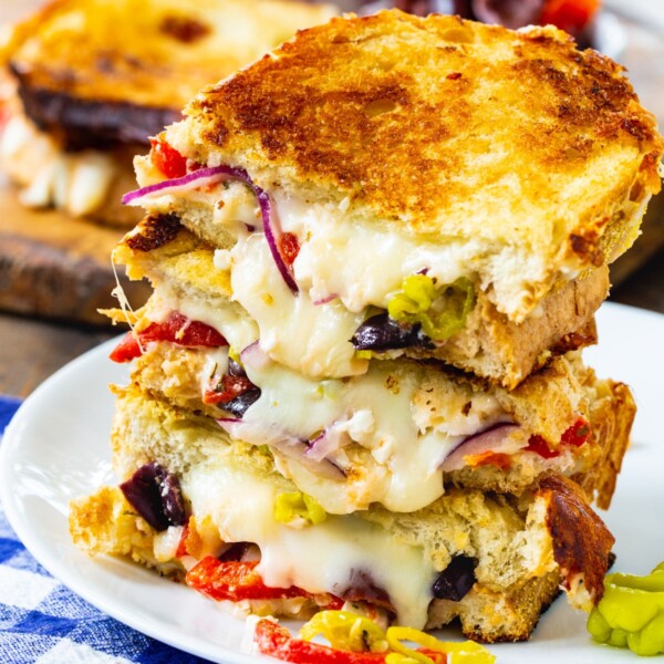 Greek Grilled Cheese halves stacked on a plate.