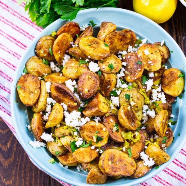 Greek Potatoes in a light blue bowl.