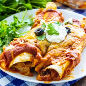 Two Beef Enchiladas on a white plate with cilantro