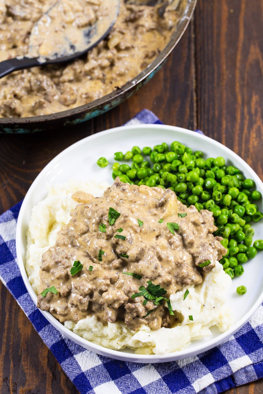 Ground Beef Gravy over mashed potatoes with peas.