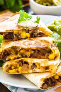 Ground Beef Quesadillas cut into wedges and piled on a plate.