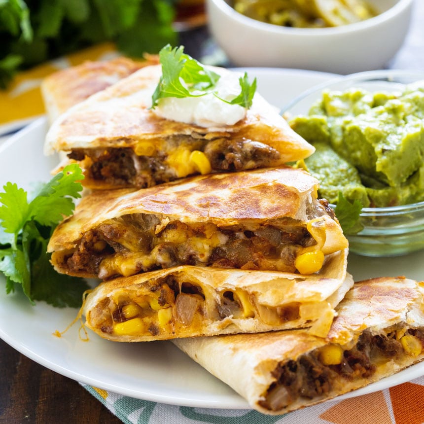 Quesadillas with cheesy ground beef filling on a white plate