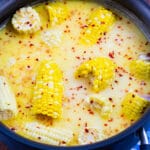 Southern Hot Honey Butter Corn in a large pot with milk, butter mixture.