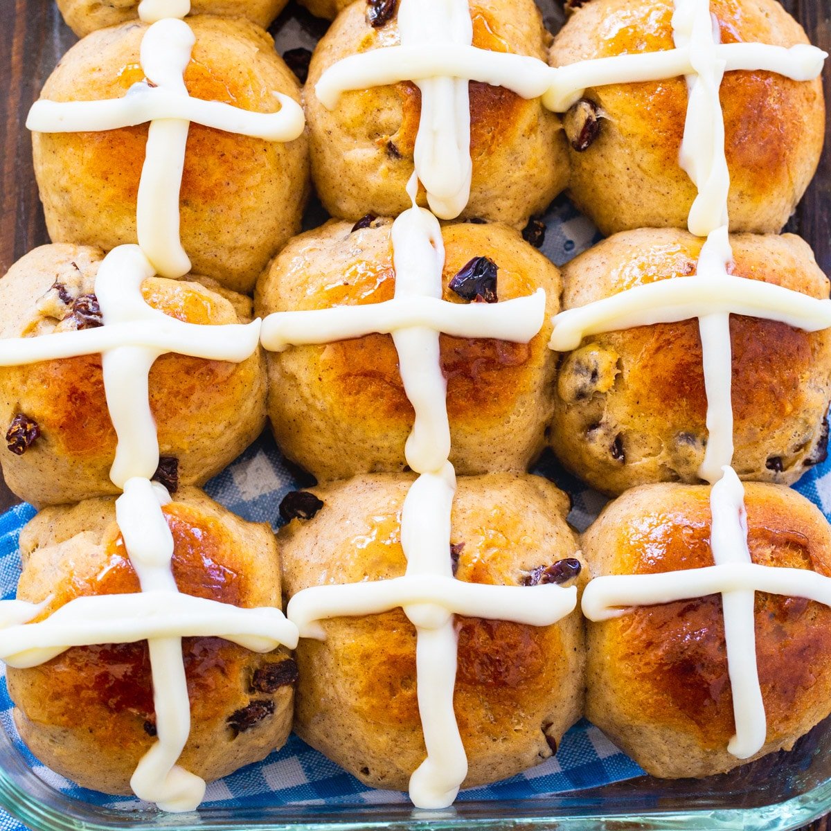 Nine Hot Cross Buns on a baking sheet.