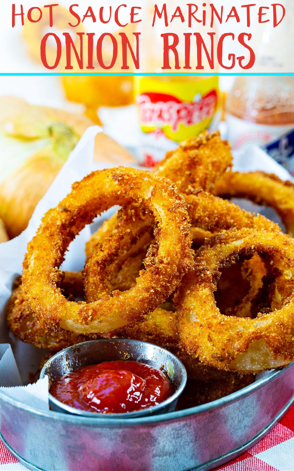 Hot Sauce Marinated Onion Rings in metal container with ketchup.