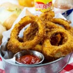 Hot Sauce Marinated Onion Rings in a serving dish with ketchup.