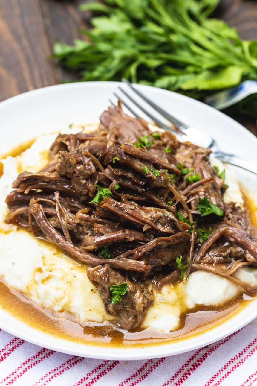 Easy 3-Packet Pot Roast served over mashed potatoes.